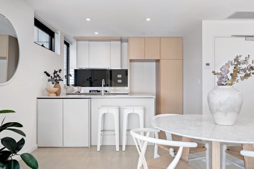 a kitchen and dining area with a white table and chairs