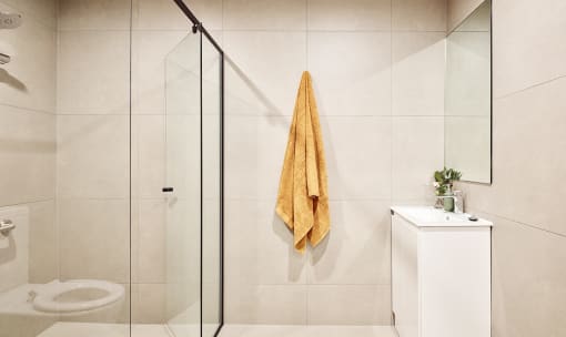 a towel hanging on the wall in a bathroom next to a shower
