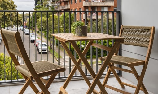 a patio with a table and chairs on a balcony