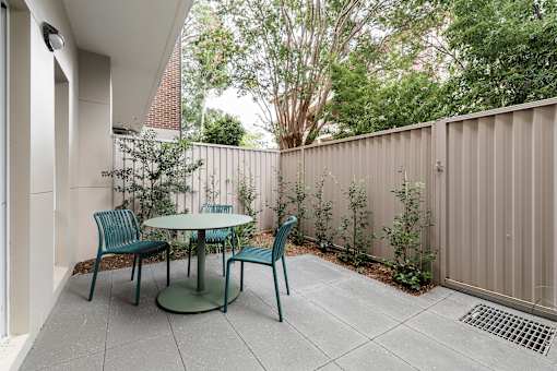 A patio with a table and chairs.