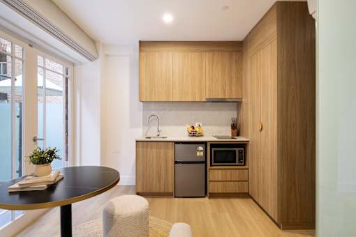 A modern kitchen with wooden cabinets and a black countertop.