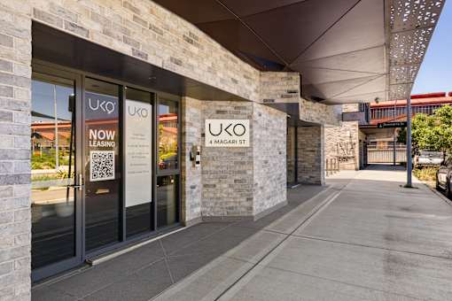 The image shows the exterior of a Uko leasing office with a modern design.