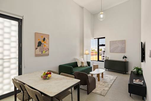 A modern living room with a dining table and chairs.