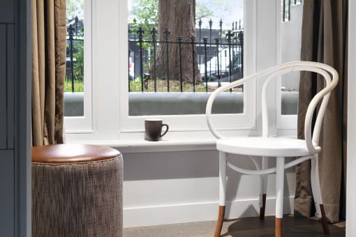 a chair and a table in front of a window
