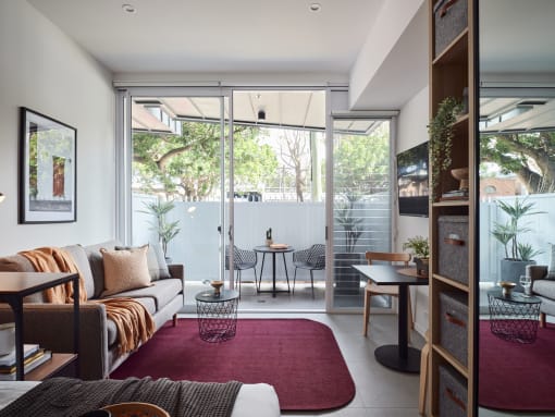 a living room with a couch and a sliding glass door to a patio