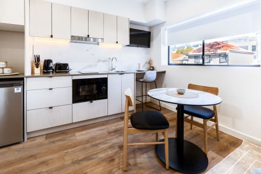 a kitchen and dining area with a small table and chairs