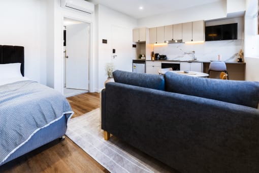 a living room with a couch and a bed