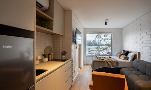 a small apartment with a bed and a kitchen
