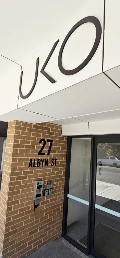 the entrance to the building is shown with a sign that reads 27 alwyn st