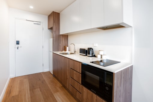 a kitchen with wooden cabinets and a counter top and a sink