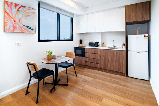 a kitchen and dining area with a table and chairs