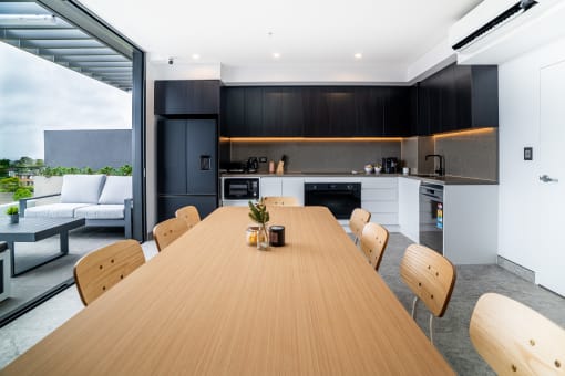 a kitchen and dining area with a wooden table and chairs