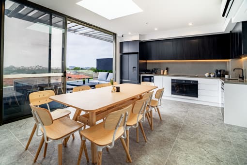 a kitchen and dining area with a wooden table and chairs