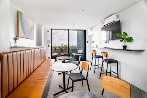 a dining room with tables and chairs and a bar