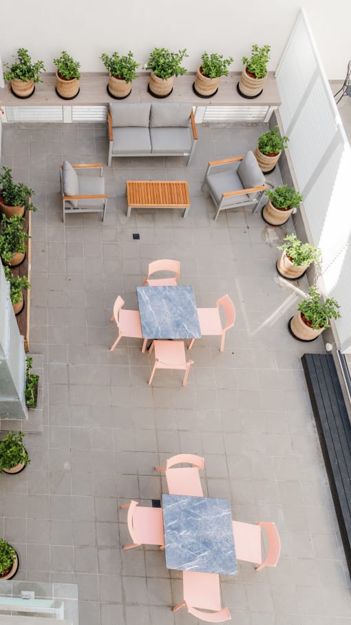 arial view of a patio with tables and chairs and potted plants