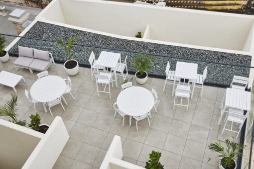 an aerial view of a patio with chairs and tables
