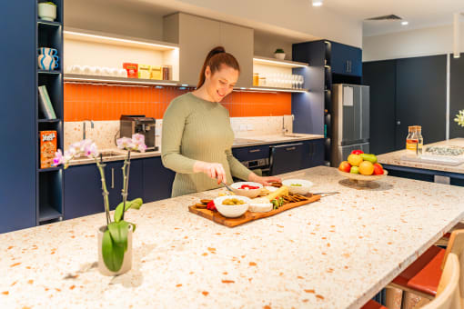 a woman preparing food in a kitchen