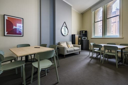 a dining room with tables and chairs and a couch