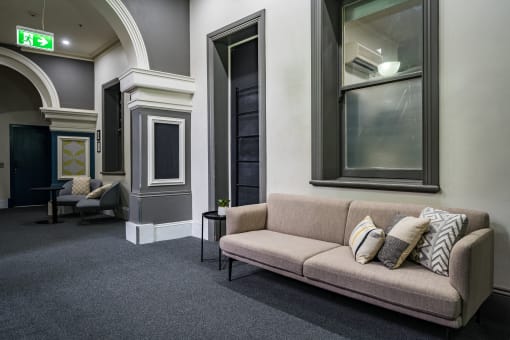 a living room with a couch and pillows on it