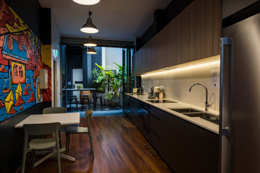 a kitchen with wooden cabinets and a table and chairs