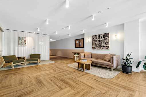 A living room with a wooden floor and furniture.