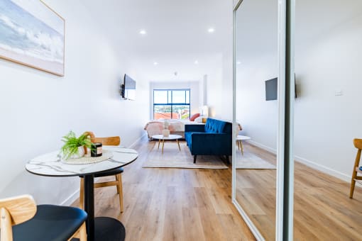 a living room with a blue couch and a table