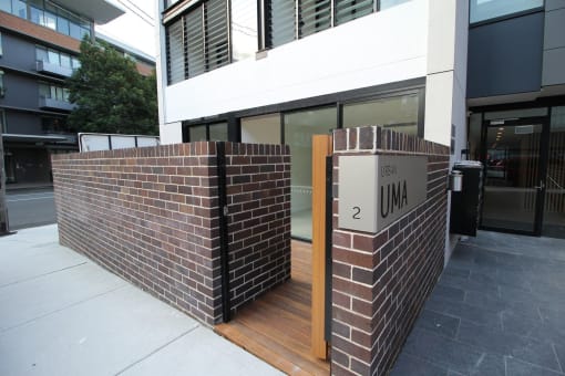 the entrance to a building with a brick wall and a sign that reads 2 um