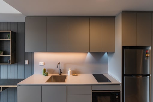 a kitchen with white counter top and stainless steel appliances