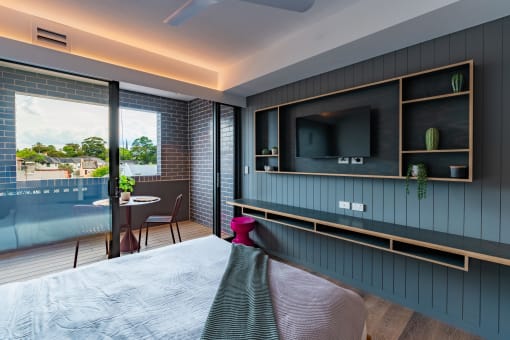 a hotel room with a bed and a tv on the wall