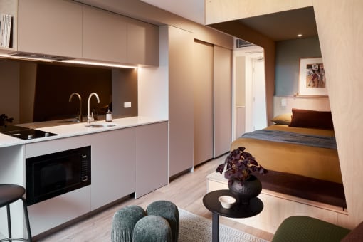 a small apartment with a bed and a kitchen
