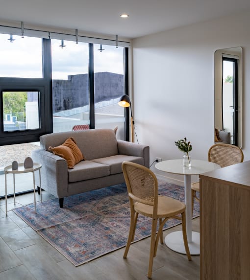 a living room with a couch and chairs and a table