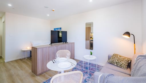 a living room with a couch and a table and a television