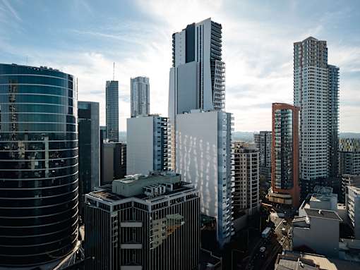 A cityscape with tall buildings and a clear sky.