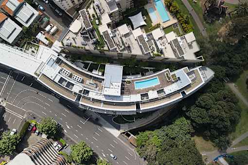 A bird's eye view of a residential area with a swimming pool.