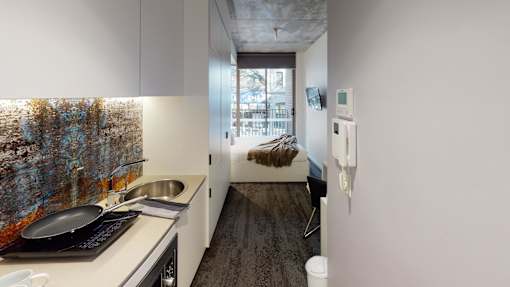 A kitchen with a sink and a window.
