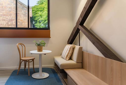 a living room with a couch and a table and a window