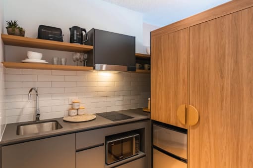 a kitchen with a sink and a wooden cabinet
