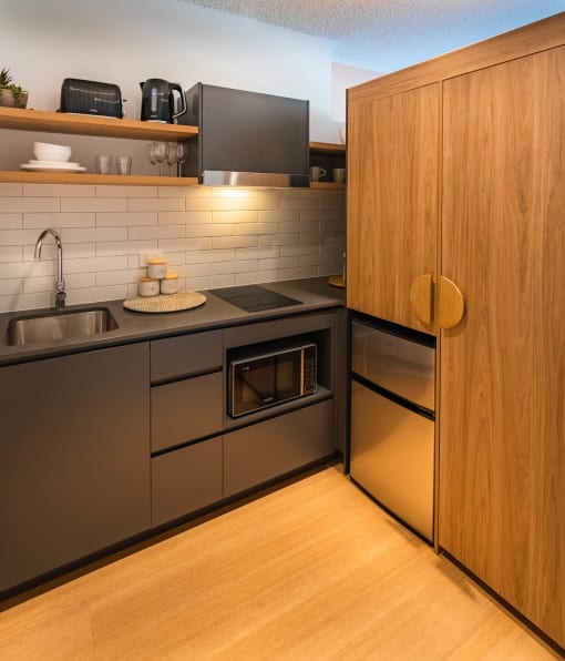 a kitchen with stainless steel appliances and a wood floor