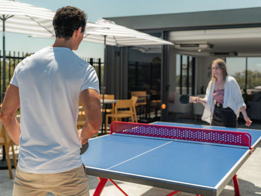 a man and a woman playing ping pong on a table