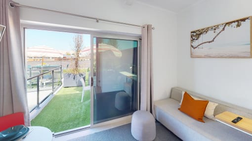 a living room with a couch and a sliding glass door