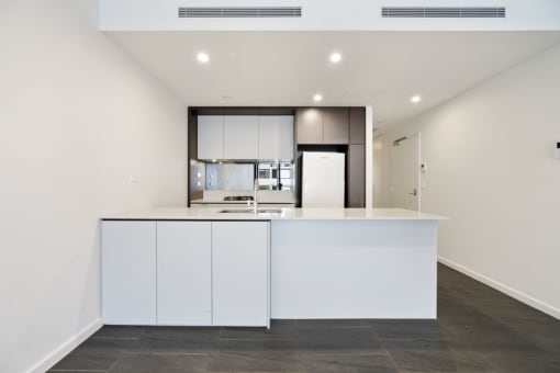 a kitchen with white cabinets and a white counter top
