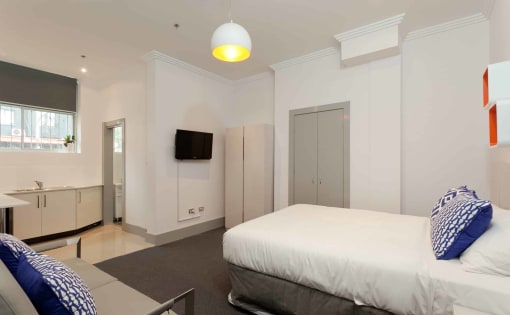 a bedroom with a bed and a tv