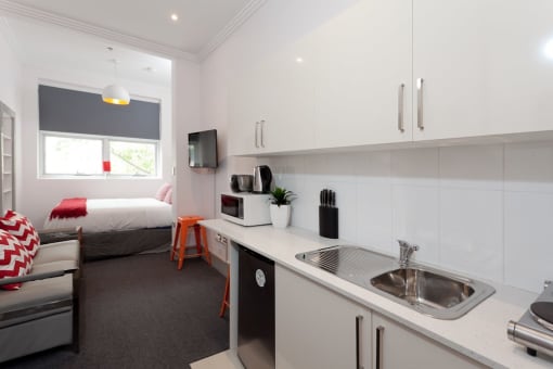a small kitchen in a room with a bed