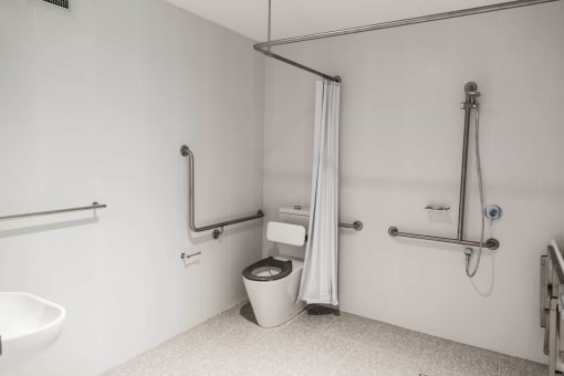 a bathroom with a toilet and a shower and a sink