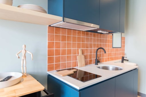 a kitchen with blue cabinets and a sink and a counter top