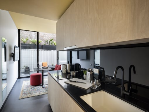 the kitchen and living area of a modern house