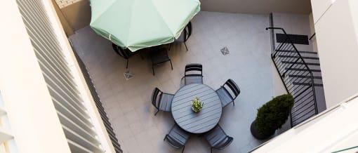 an aerial view of a patio with a table and chairs