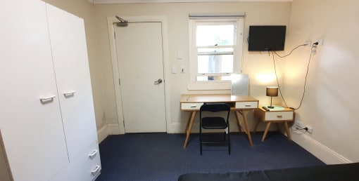 a small room with a desk and a window