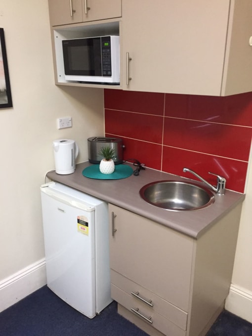 a small kitchen with a sink and a microwave