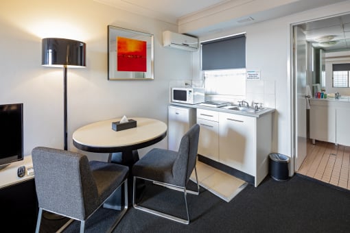 a kitchen and dining room with a table and chairs